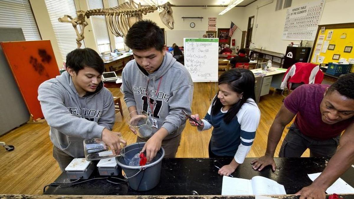 A physics experiment was conducted recently by Isidro Torres (from left), Jonathan Sang, Adriana Sabado and Yaseen Chapell at Wyandotte High School in Kansas City, Kan.