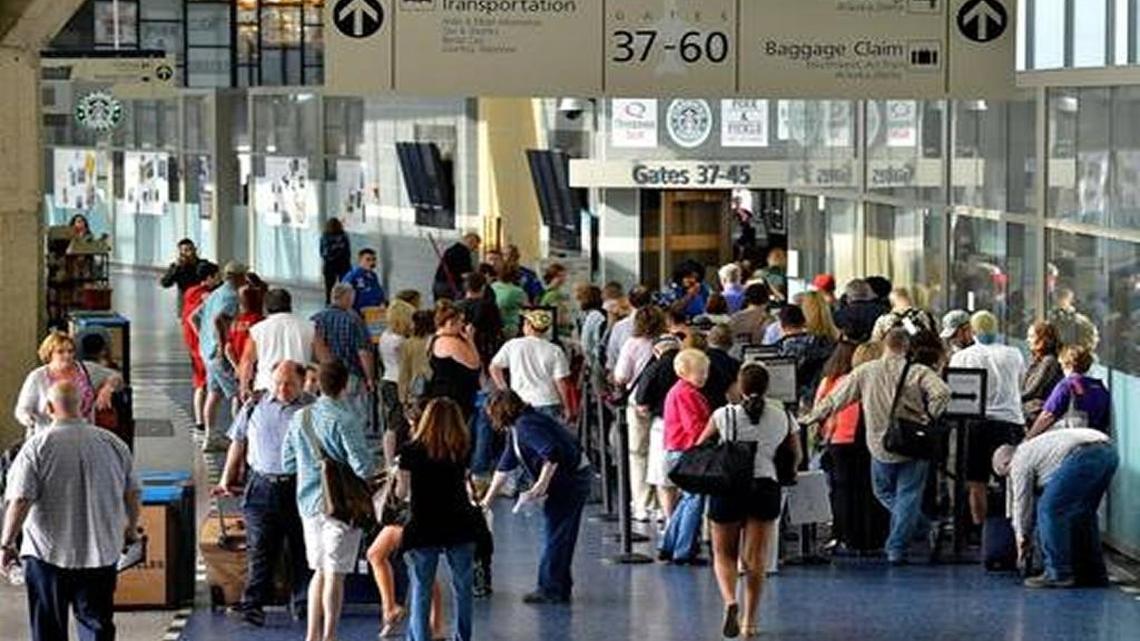 Passengers line up to enter gates at Kansas City International Airport.