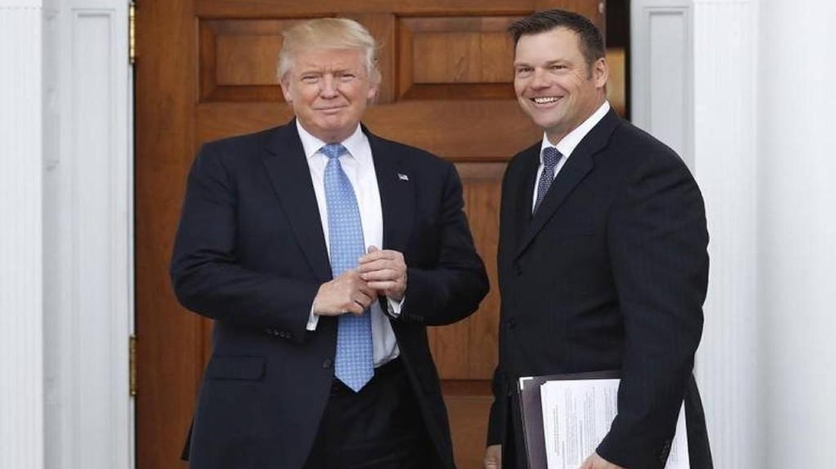 Kansas Secretary of State Kris Kobach held a stack of papers as he met on Nov. 20, 2016, with then President-elect Donald Trump at the Trump National Golf Club in Bedminster, N.J.