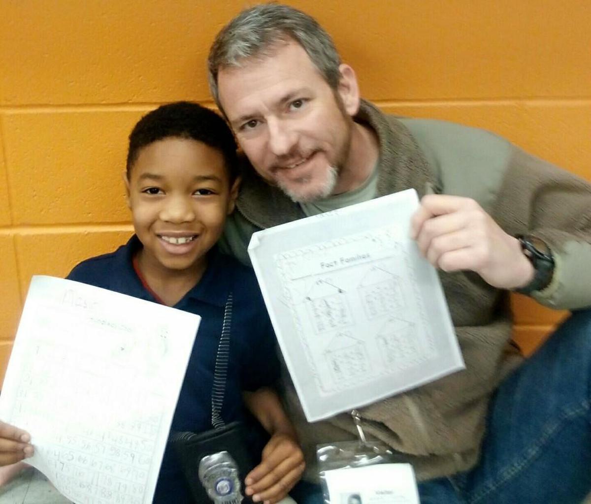 Kelly Sapp (right) is a mentor to Nasir, 6, in the Lead to Read program. Sapp is walking halfway across the state to speak with Gov. Eric Greitens in part to raise awareness for children’s safety in Kansas City.