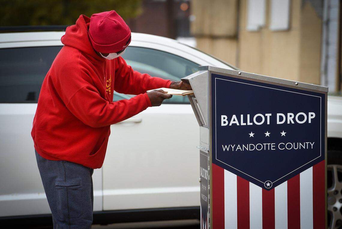 A voter drops off their ballot at a drop box in Wyandotte County during the 2020 election. Ballot drop boxes are a point of division between hard-right conservative candidate Mike Brown and incumbent Secretary of State Scott Schwab in the GOP primary race.