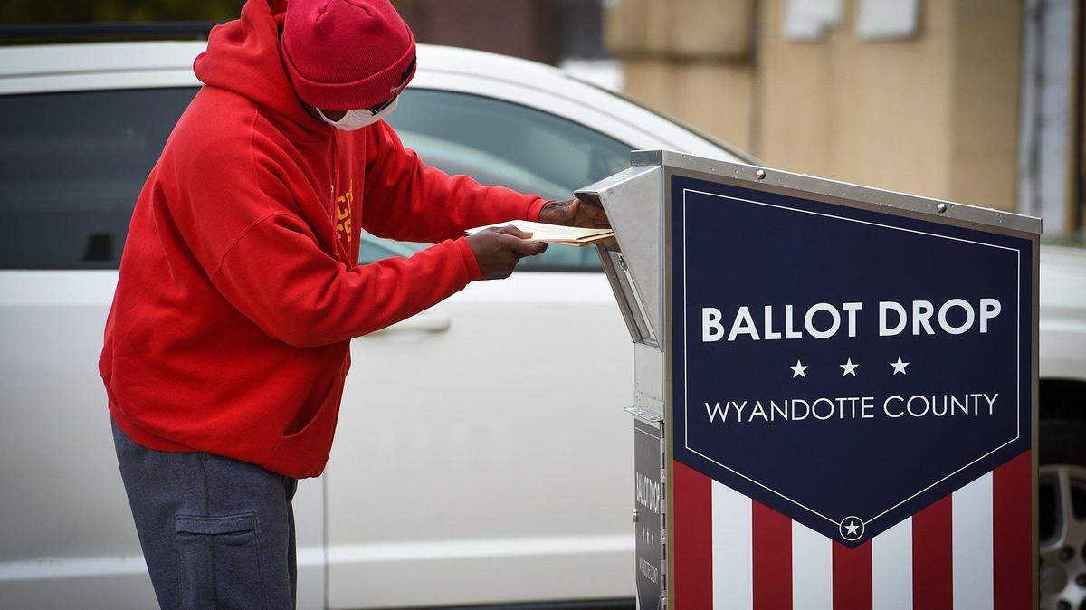A voter drops off their ballot at a drop box in Wyandotte County during the 2020 election. Kansas Secretary of Scott Schwab supports the use of drop boxes, but some Republicans oppose their use.