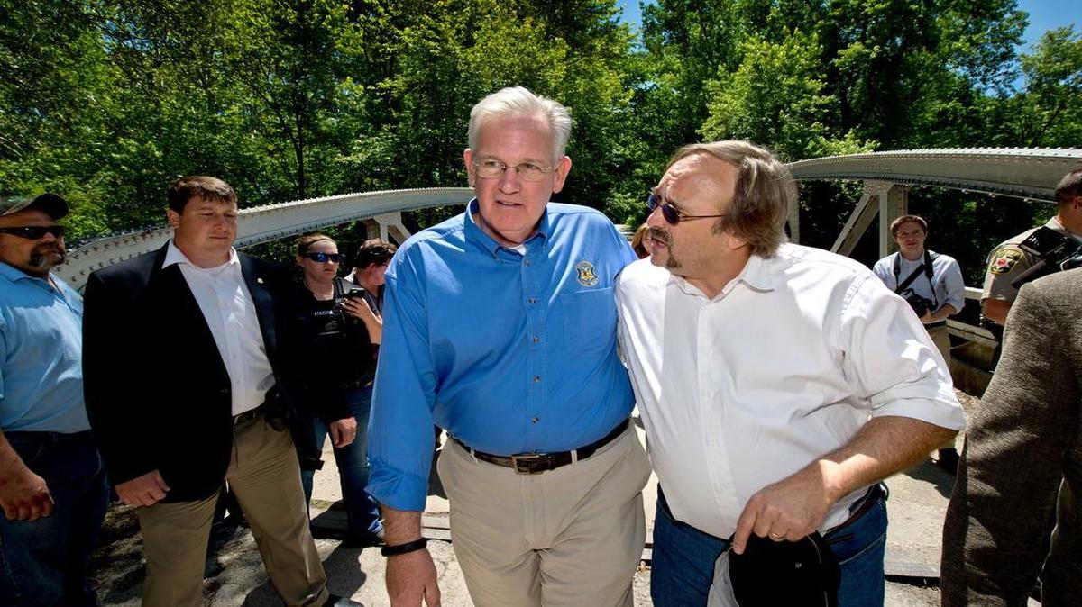 
Missouri Gov. Jay Nixon conferred with Jerry Nolte, Clay County presiding commissioner, on Monday while touring the flood-damaged town of Mosby. They were on a bridge over the Fishing River, which went out of its banks early Sunday, forcing many residents of the town to evacuate.

