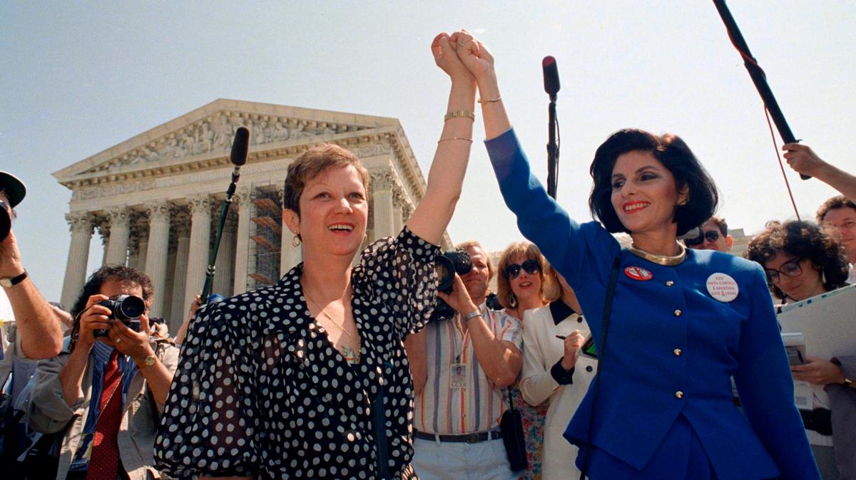 Norma McCorvey, Jane Roe in the 1973 court case, left, and her attorney Gloria Allred hold hands as they leave the Supreme Court building in Washington after sitting in while the court listened to arguments in a Missouri abortion case, April 26, 1989. A leaked draft of a U.S. Supreme Court decision suggests the country’s highest court could be poised to overturn the constitutional right to abortion, allowing individual states to more heavily regulate or even ban the procedure. (