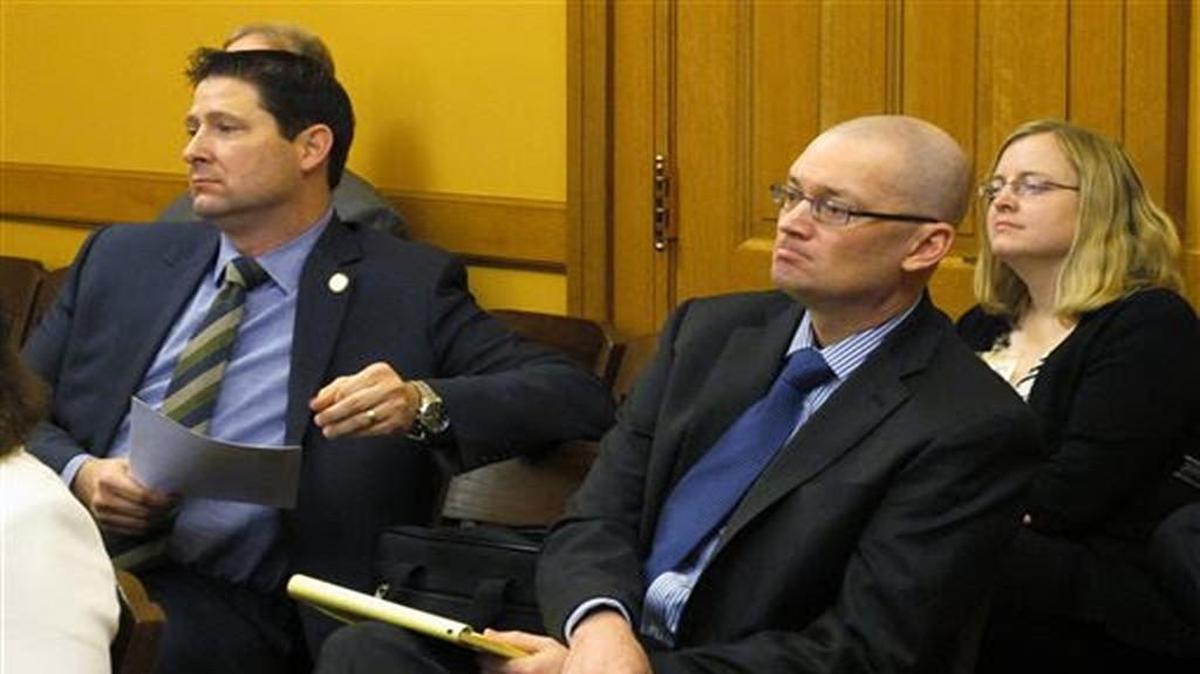 Toby Crouse (center right), an Overland Park lawyer, listened Thursday as legislative leaders decided to hire him to represent lawmakers in a school funding lawsuit. Sitting with Crouse at the Kansas statehouse was House Appropriations Committee chairman Ron Ryckman Jr., an Olathe Republican, who helped find Crouse.