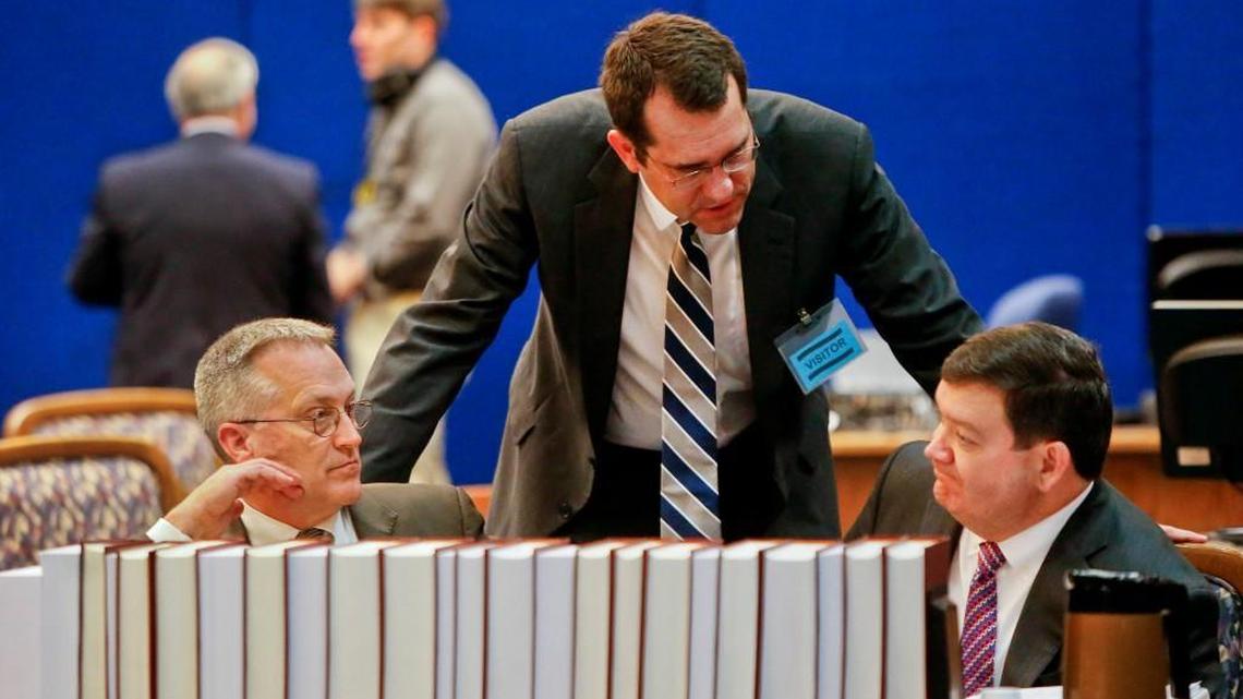 Kansas Attorney General Derek Schmidt, center, speaks with then-Solicitor General Stephen McAllister, right, during a recess at a 2016 Kansas Supreme Court hearing. McAllister, who went onto serve as U.S. attorney, said he will support Democratic Gov. Laura Kelly over Schmidt in November.