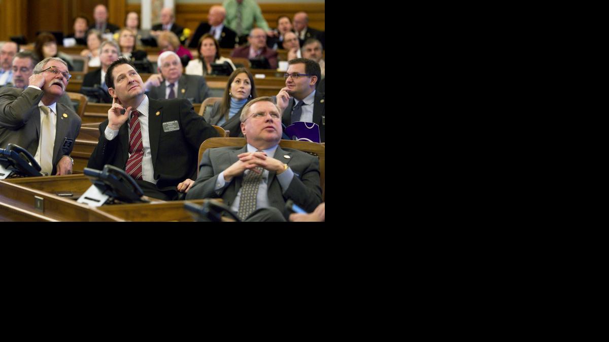 
Members of the Kansas House, including House Appropriations Chairman Rep. Ron Ryckman Jr., R-Olathe, center, watch the vote boards Wednesday as the House gave its final approval to a measure intended to keep the state afloat financially. 
