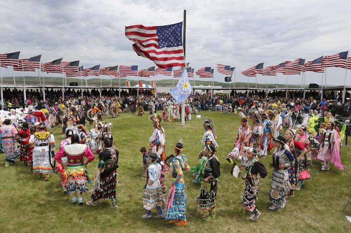 Native American dancers from more than 20 reservations in North and South Dakota perform before the arrival of President Barack Obama and first lady Michelle Obama on the Standing Rock Indian Reservation Friday, June 13, 2014, in Cannon Ball, N.D. President Obama is making his first presidential visit to Indian Country for a look at two sides of Native American life, a celebration of colorful cultural traditions on the powwow grounds and a view of the often bleak modern-day conditions on tribal lands.