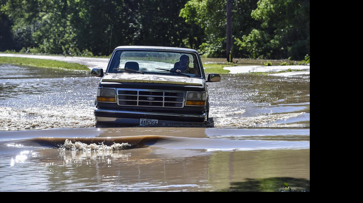 
Harlin Clements, mayor of Mosby, Mo., drives through flood waters on Sunday, May 17, 2015, in Mosby. Residents were slowly making their way back to their homes after the city, near Excelsior Springs, was evacuated Sunday morning due to flooding.
