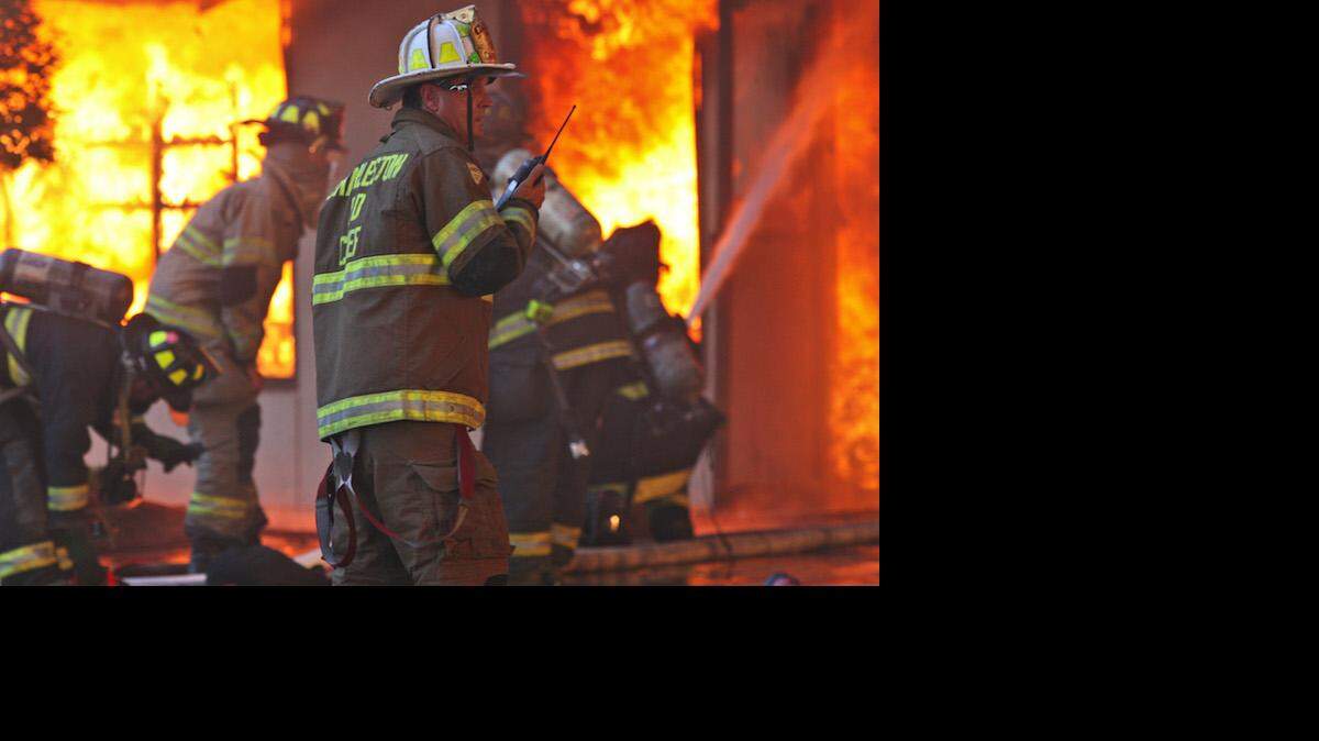 Chief Rusty Thomas directs Charleston firefighters battling a fire that destroyed the Sofa Super Store in Charleston, S.C. Monday, June 18, 2007.