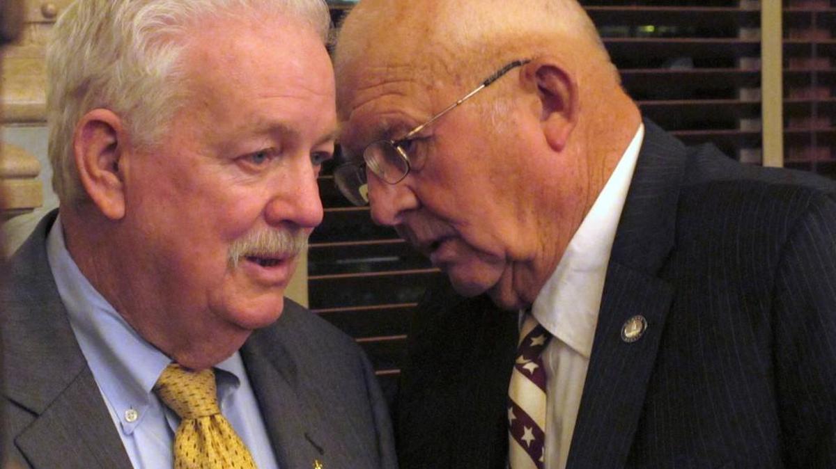 Kansas House Speaker Ray Merrick, left, R-Stilwell, confers with state Sen. Ralph Ostmeyer, right, R-Grinnell, during the Senate’s debate on a budget-balancing plan early Monday morning, May 2, at the Statehouse in Topeka, Kan. The plan approved by lawmakers requires Gov. Sam Brownback to do most of the work in balancing the budget.