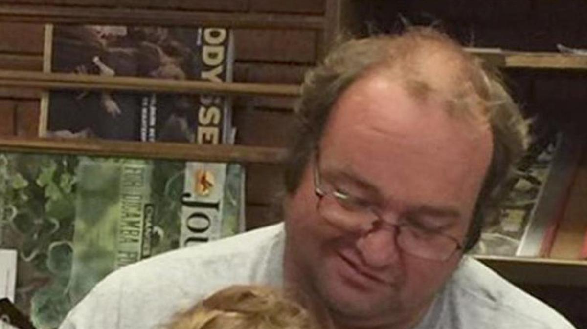 Steven Myers reads a book to his daughter Kaylee.