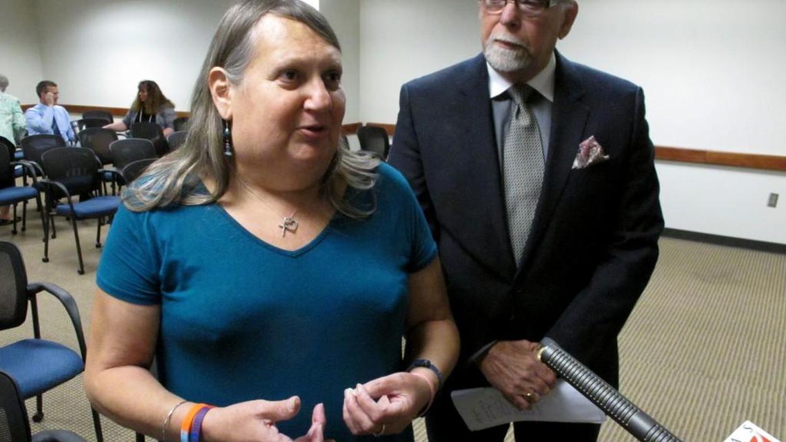 Stephanie Mott, left, a transgender Topeka woman and activist, and Pedro Irigionegaray, right, her attorney, speak to reporters following a state health department hearing on regulatory changes that would make it more difficult to change the gender listed on a person’s birth certificate Thursday in Topeka. Mott predicts the changes will cause more transgender youth to attempt suicide and has told state officials, “These regulations will be written in their blood.”