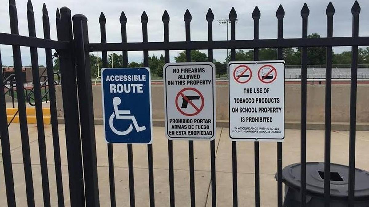 A sign posted in front of Hillier Stadium at Augusta High School state that firearms are not allowed on the school property where two people were shot at a graduation ceremony last May.