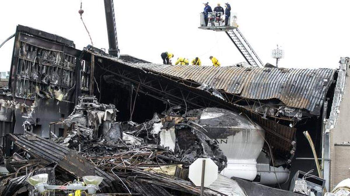 
Construction crews hired by the National Transportation Safety Board on Monday brought in heavy equipment to take large pieces of debris off the roof of a building where a small plane crashed last week at Wichita Mid-Continent Airport, killing four people.
