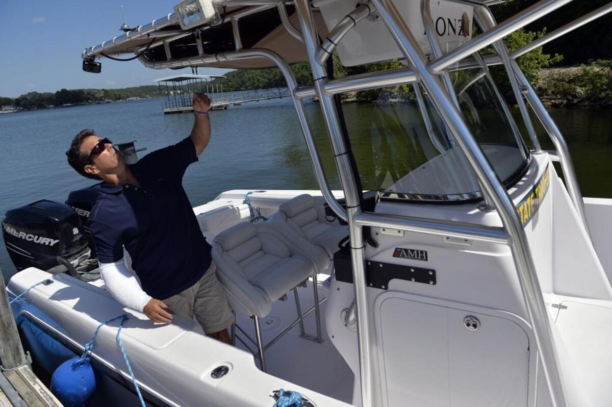In this file photo, Craig Ellingson inspected the boat that carried his son Brandon before he drowned in May 2014. Brandon Ellingson, of Clive, Iowa, drowned while in the custody of Missouri Trooper Anthony Piercy on the Lake of the Ozarks.