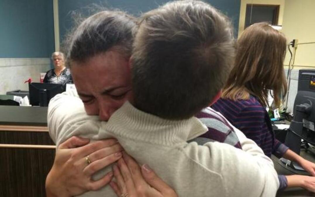
Lilly Leyh, left, cries as she hugs her partner, Sadie Pierce, center, while filling out an application for a marriage license at City Hall in St. Louis
