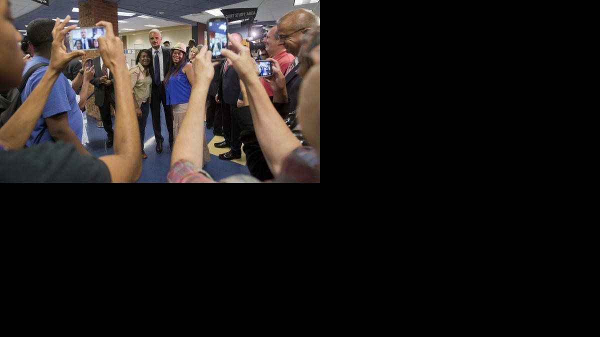 
Attorney General Eric Holder, center, poses for photographs following his meeting with students at St. Louis Community College Florissant Valley near Ferguson, Mo.
