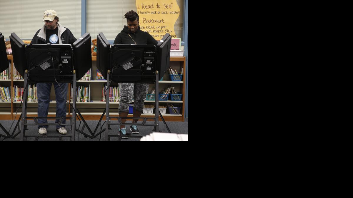
Rich Baranowski, left, and Tracy Hardy vote in Ferguson's municipal election Tuesday,
