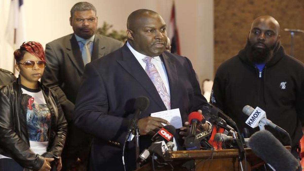 
Attorney Daryl Parks, center, talks to reporters as Lesley McSpadden, left, and Michael Brown Sr., right, parents of 18-year-old Michael Brown Jr., listen during a news conference, Thursday

