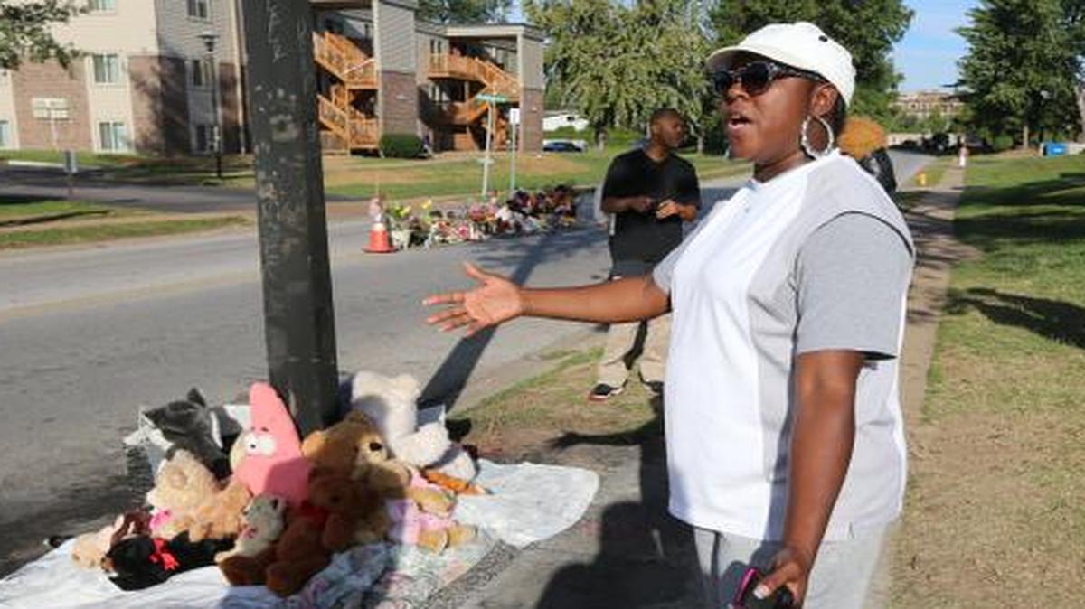 
A woman gestures by a new teddy bear memorial on Tuesday, Sept. 23, 2014, in Ferguson, Mo., near the spot of where Michael Brown was shot by Ferguson police office Darren Wilson.

