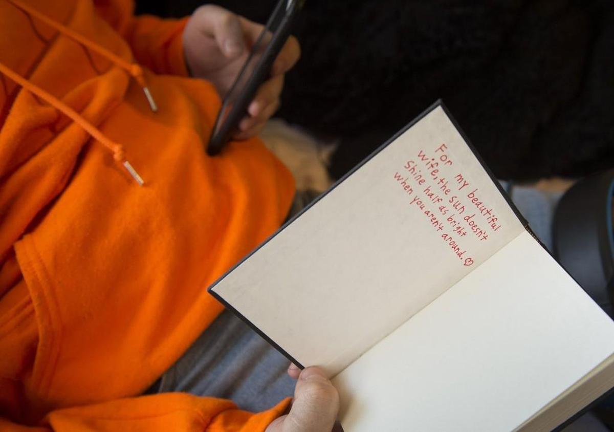 Dylan Knowles, 17, displays a journal entry he wrote for his 15-year-old wife, Samantha.