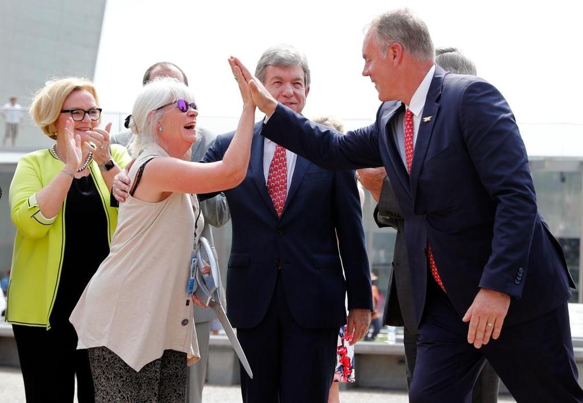 Susan Saarinen, daughter of Gateway Arch architect Eero Saarinen, was congratulated by U.S. Interior Secretary Ryan Zinke as U.S. Sens. Claire McCaskill and Roy Blunt watched. Saarinen cut the ribbon dedicating the completion of renovations to the Arch and its grounds on Tuesday.