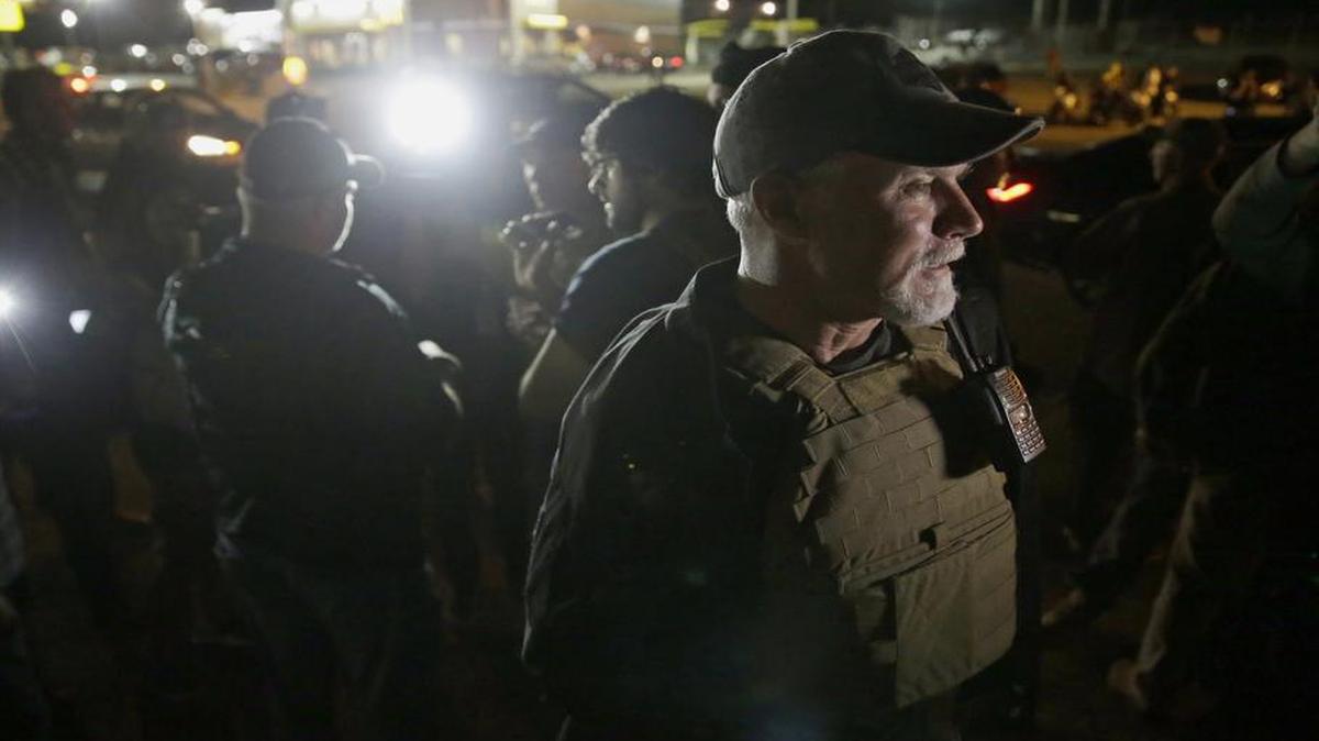 
Heavily armed civilians talk to members of the media in Ferguson, Mo. Tuesday
