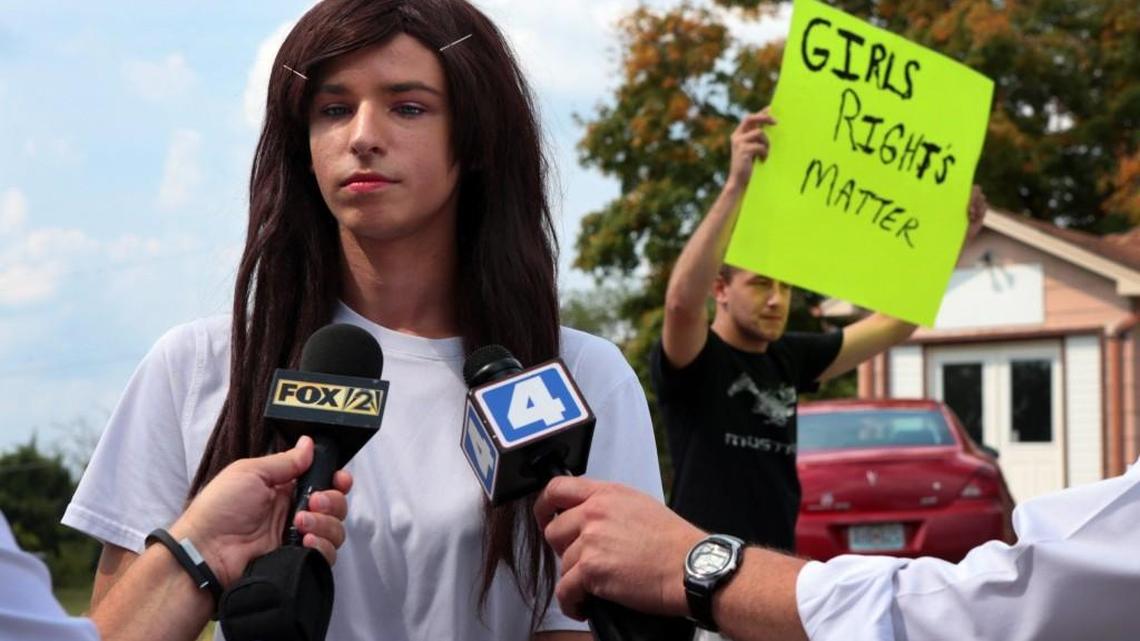 
Lila Perry, a Hillsboro High School senior and transgender student, spoke on Monday with reporters as Blayke Childs (back) offered his opinion after a student walkout at Hillsboro High School over Perry’s request to use the girls bathrooms and locker rooms rather than a unisex faculty bathroom. 
