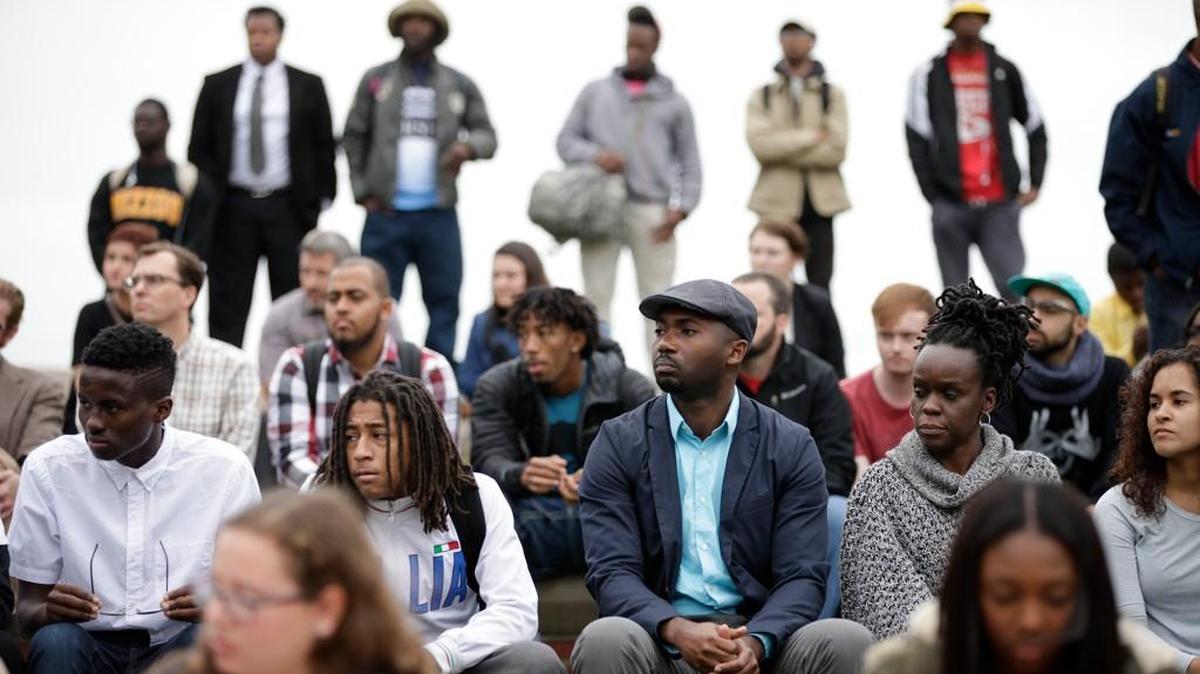 Supporters of the group “Concerned Student 1950” listen to speeches during a rally, Wednesday at Traditions Plaza on the University of Missouri campus in Columbia, Mo., calling for the resignation of the University of Missouri System President Tim Wolfe.