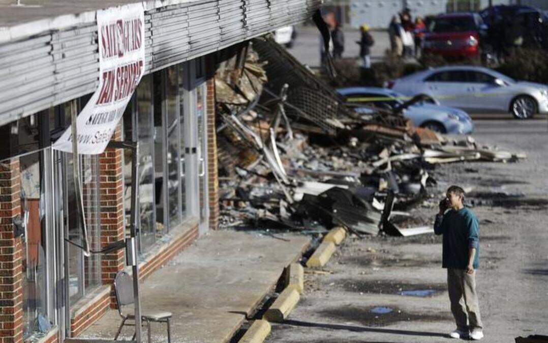 
Restaurant owner Shan Zhao looked at his business while cleaning up Tuesday in Ferguson, Mo., after it was damaged in protests following a grand jury’s decision not to indict white police officer Darren Wilson in the killing of unarmed black 18-year-old Michael Brown.
