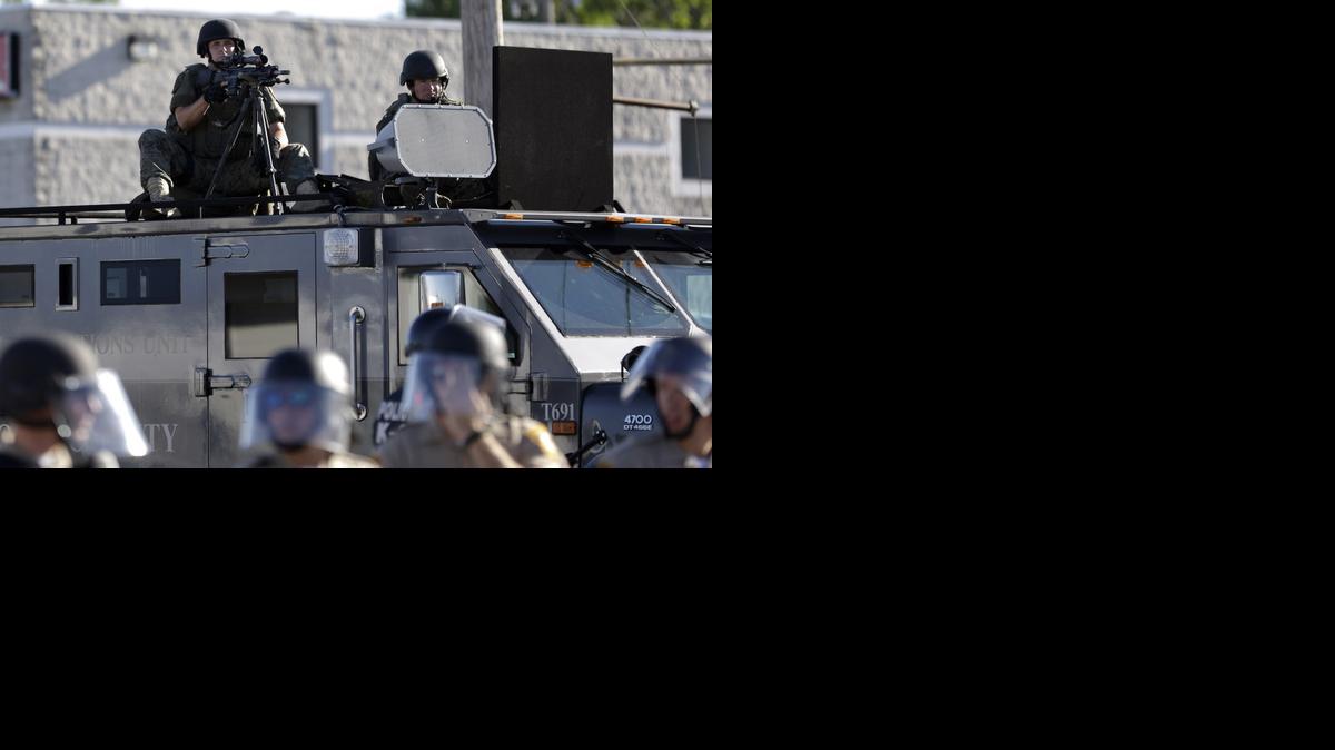 
A police tactical team moves in to disperse a group of protesters in Ferguson, Mo., last August.
