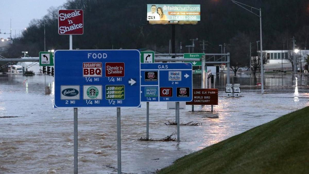 Water flows off the Interstate 44 exit ramp at Highway 141 in Fenton, a suburb of St. Louis on Wednesday
