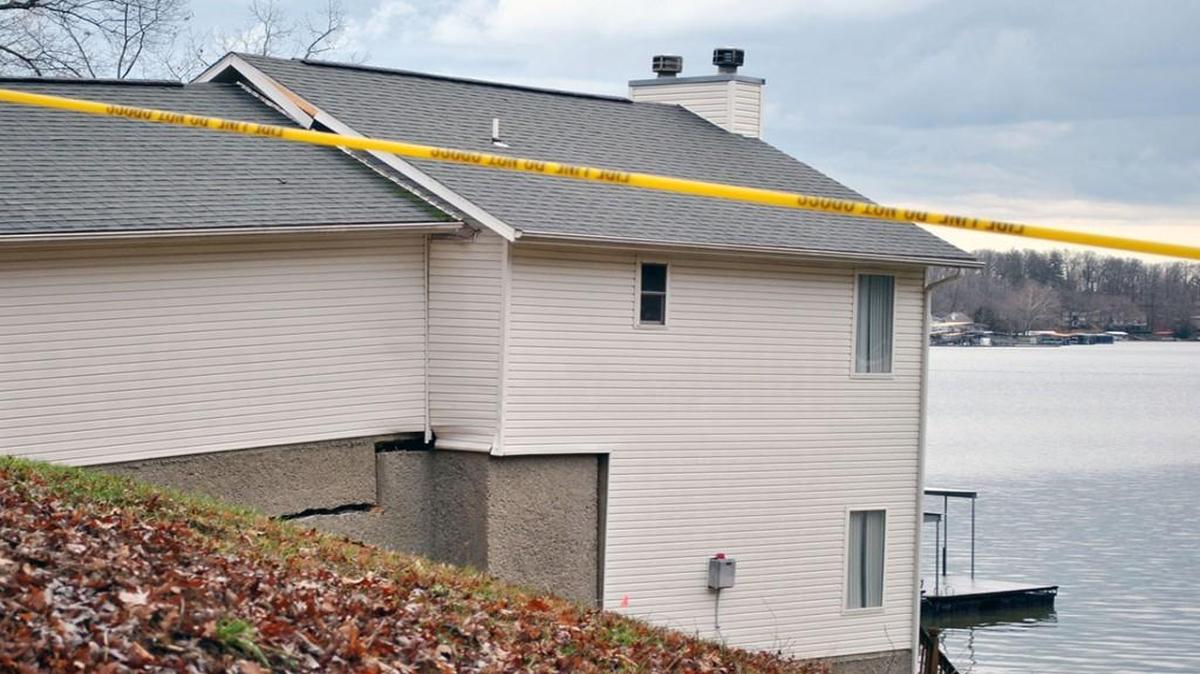 The ground above the home has shifted and the foundation, roof, seawall and other parts of the home have cracked as this home at Cub Cove Point north of Camdenton has slid three feet toward the Lake of the Ozarks.