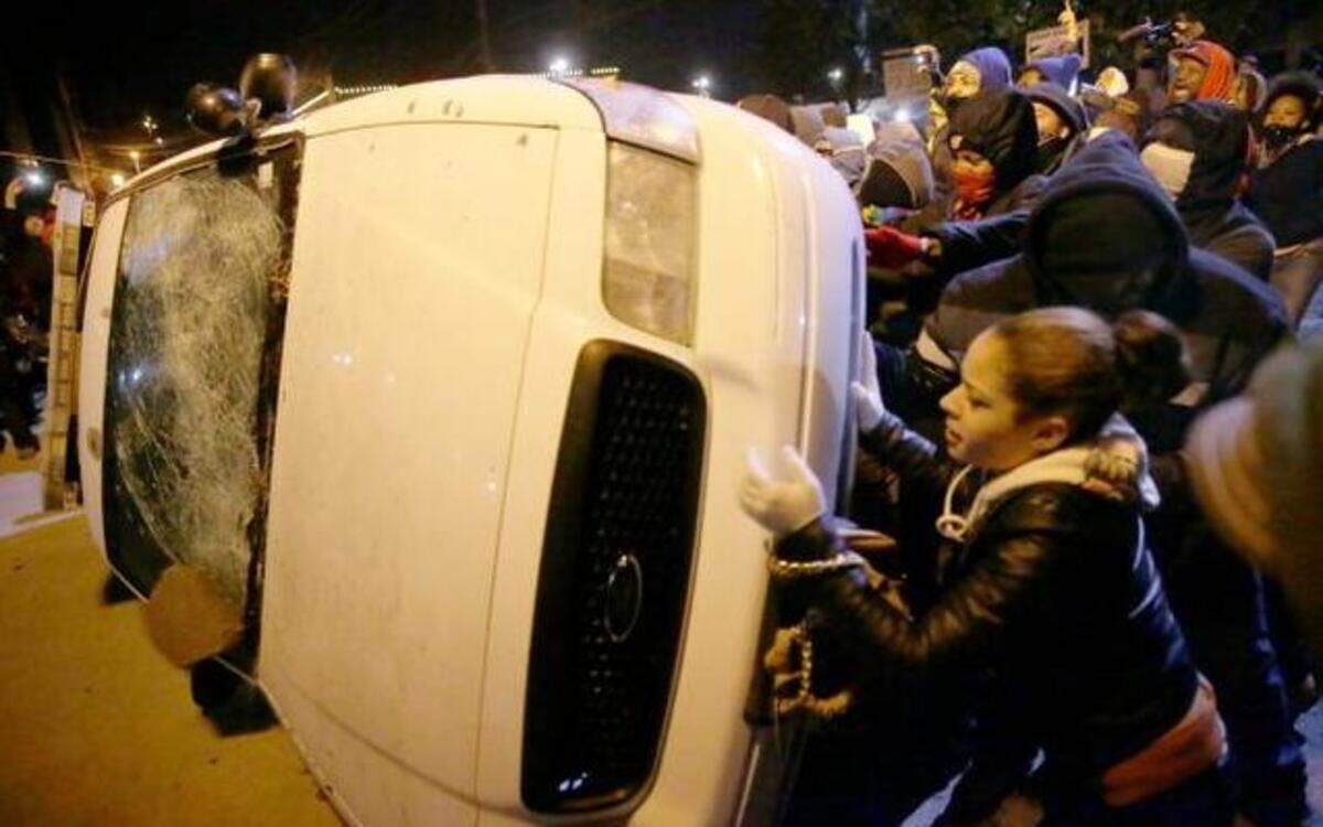 
In spite of the increased presence of law enforcement Tuesday, destruction continued in Ferguson, Mo., as protesters overturned a police vehicle outside City Hall. 
