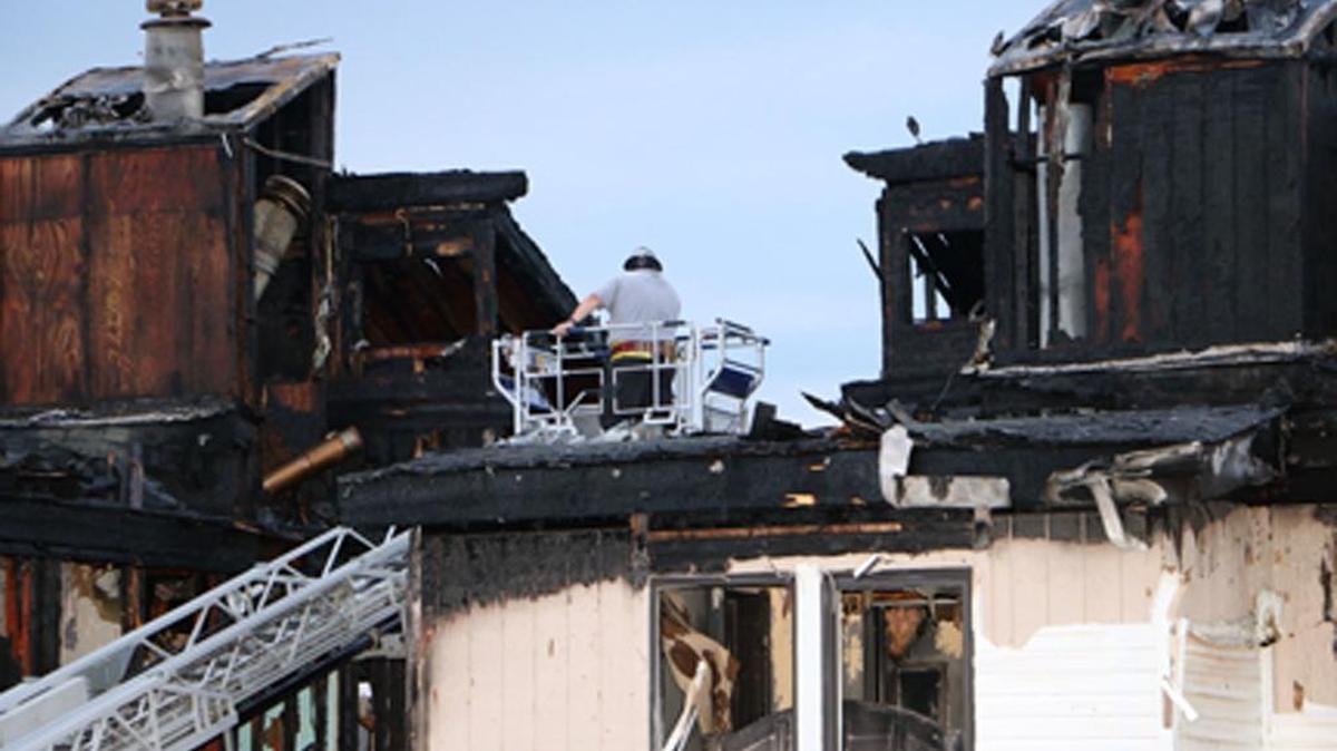 
In this photo provided by Dan Field, a fire investigator surveyed the aftermath of an overnight fire Wednesday in Osage Beach, Mo. Authorities said the fire swept through the top floor of the four-story condominium, killing four young children.
