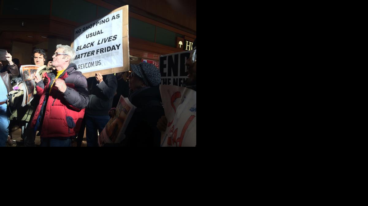 
Some of the 100 or more protestors gather outside the Galleria Mall on Friday in St. Louis. 
