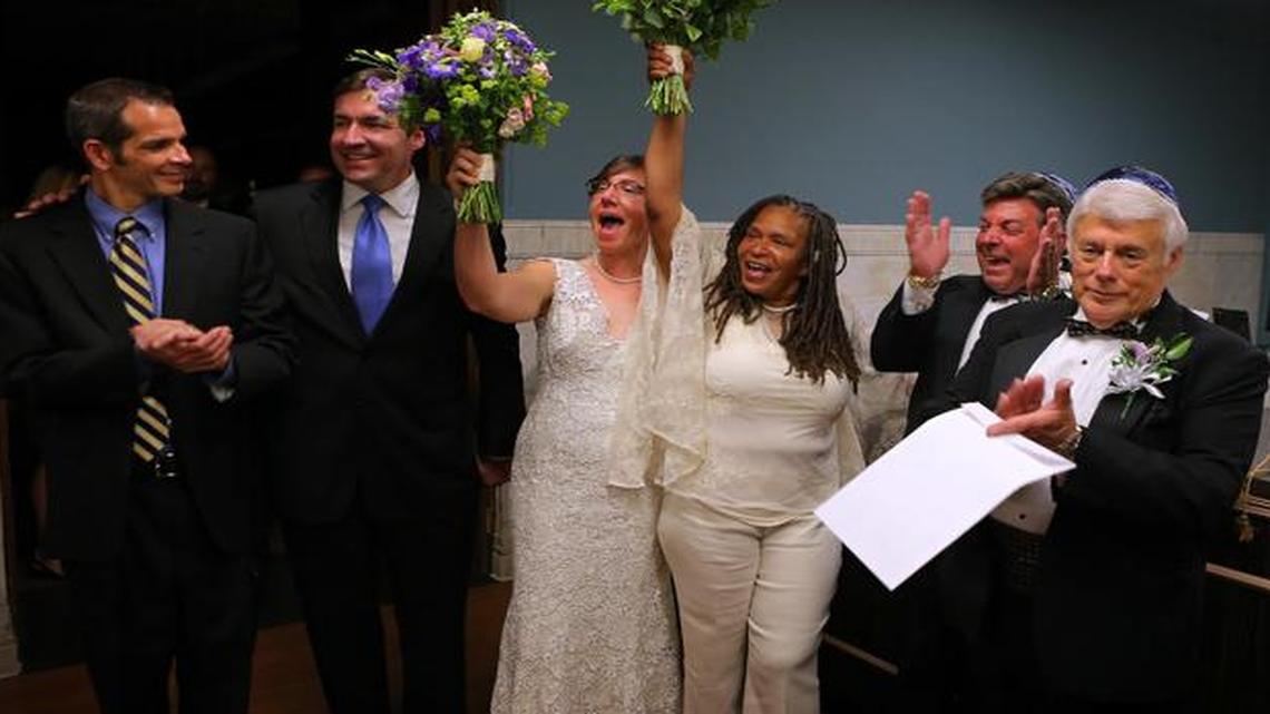 
Newly wed couples, from left, David Gray and Tod Martin, Miranda Duschack and Mimo Davis, and Terry Garrett and Bruce Yampolsky, celebrate after St. Louis Recorder of Deeds Sharon Quigley Carpenter announced she had official recorded their marriages at St. Louis City Hall. 
