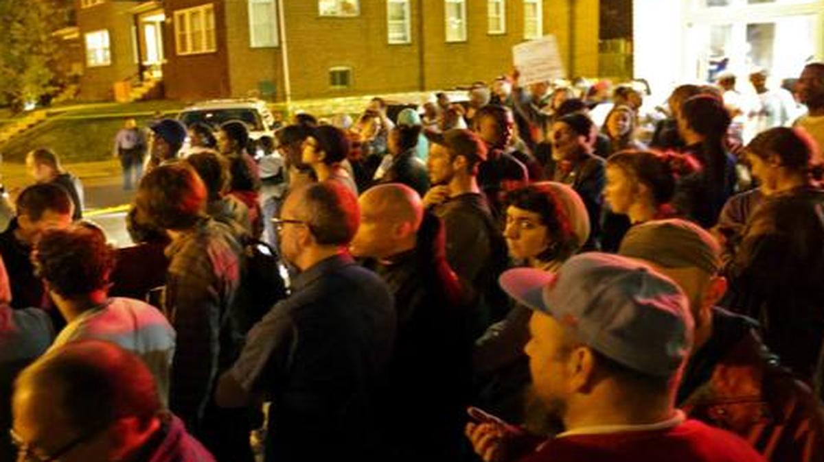 
A crowd gathers near the scene in the 4100 block of Shaw Boulevard where a man was fatally shot by an off-duty St. Louis police officer on Wednesday.
