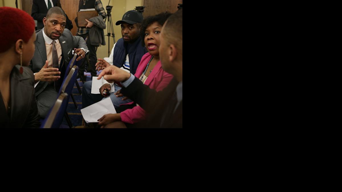 
Ferguson Commission Co-Chair Rev. Starsky Wilson, second from the left, talks with, from left, Shirlissa Pruitt, Anthony Levine, Tina Cramer and Amir Brandy 
