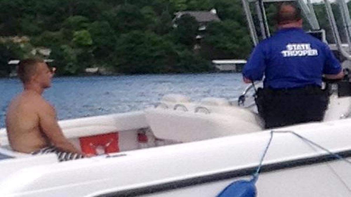 
This photo by Myles Goertz shows Brandon Ellingson in the back of Trooper Anthony Piercy’s boat on May 31. Piercy later arrested Ellingson for boating while intoxicated, cuffed his hands behind his back and put a Type III life vest on him. Because a Type III vest has armholes, it cannot be secured on a handcuffed person. Troopers are trained to use Type I life jackets on handcuffed subjects. An orange-red Type I life jacket is visible in the boat a few feet from Ellingson.
