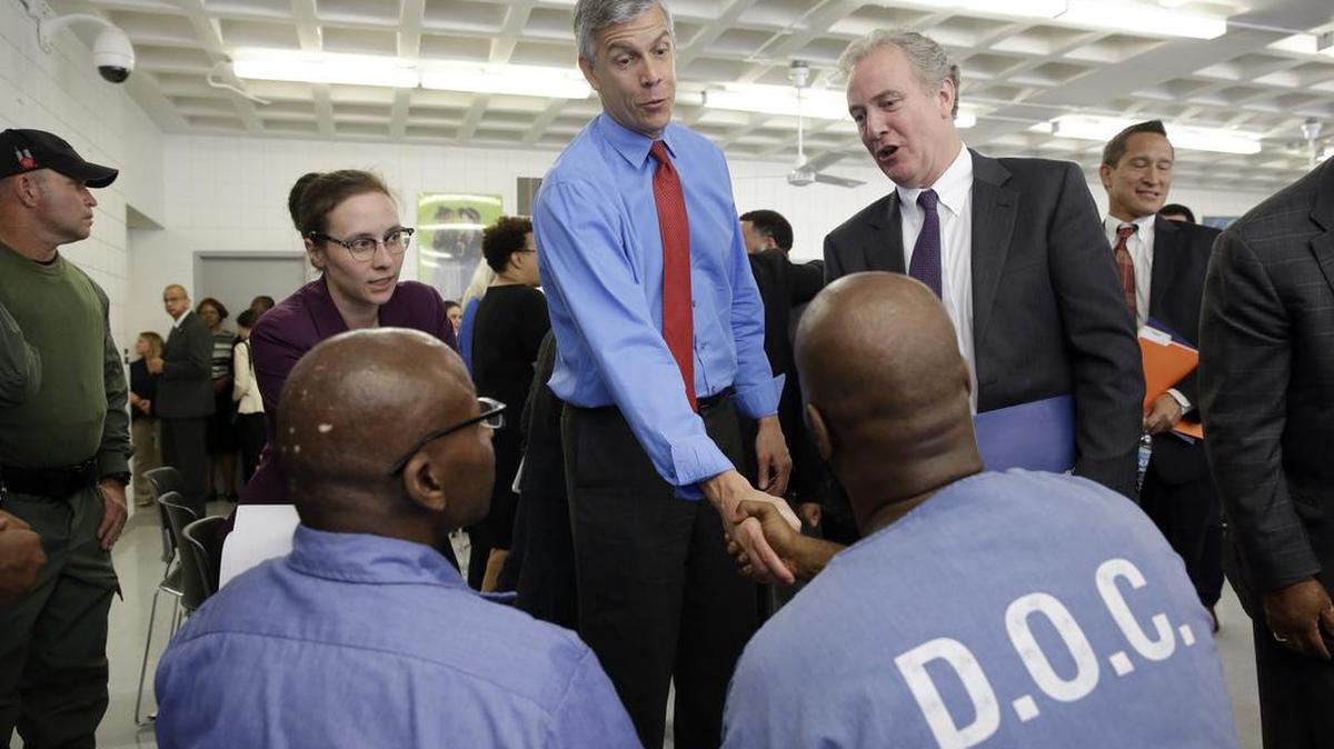 
Education Secretary Arne Duncan, center, speaks with inmates Alphonso Coates, bottom right, and Kenard Johnson, both participants in the Goucher College Prison Education Partnership at Maryland Correctional Institution-Jessup, last Friday, in Jessup, Md. After a roundtable discussion at the prison, the Education Department announced Friday that it would conduct a limited pilot program to give prisoners access to the Pell grants, allowing them to take college courses behind bars. 
