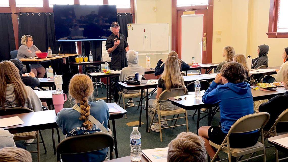 Johnny Rowlands, at front of classroom, has built a curriculum that focuses on keeping young drivers from putting themselves at any more risk than necessary. Simple strategies that are designed, he says, to lessen the likelihood that parents will ever have “to get that phone call.”