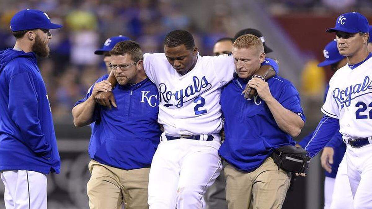 
 Royals shortstop Alcides Escobar (2) was helped off the field Friday after being injured on a force-out of the Athletics' Brett Lawrie at second.
