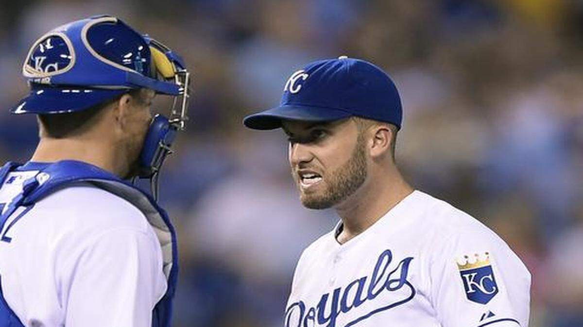
Kansas City Royals pitcher Danny Duffy (41) talked with Kansas City Royals catcher Eric Kratz (19) in the seventh inning of the game against the Cleveland Indians on Aug. 31, 2014, at Kauffman Stadium in Kansas City, Mo. Duffy will start Monday’s game after the Aug. 31 rain-suspended game is finished.
