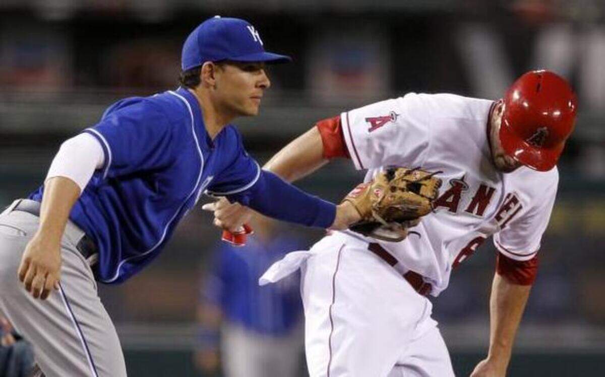 
Royals third baseman Danny Valencia tags out the Angels David Freese in a rundown between third and second base in the 10th inning of a Saturday’s baseball game in Anaheim, Calif.
