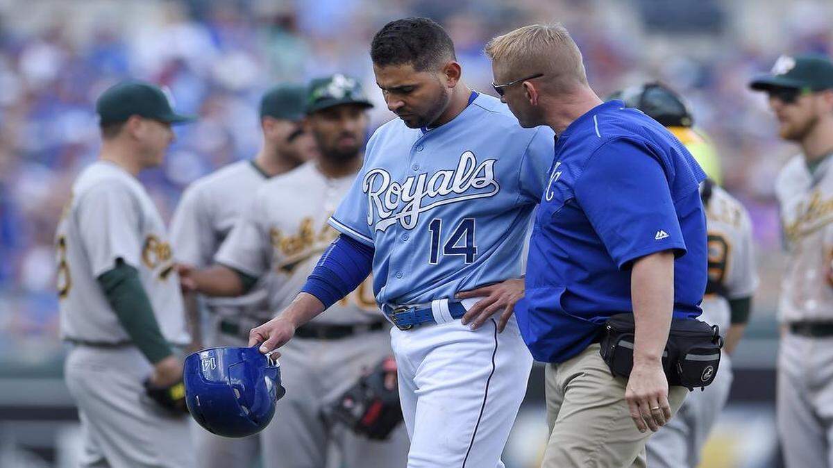 
The Royals' Omar Infante (14) walked off the field with trainer Nick Kenney after pulling up lame running the basesduring Sunday's baseball game against the Athletics at Kauffman Stadium.
