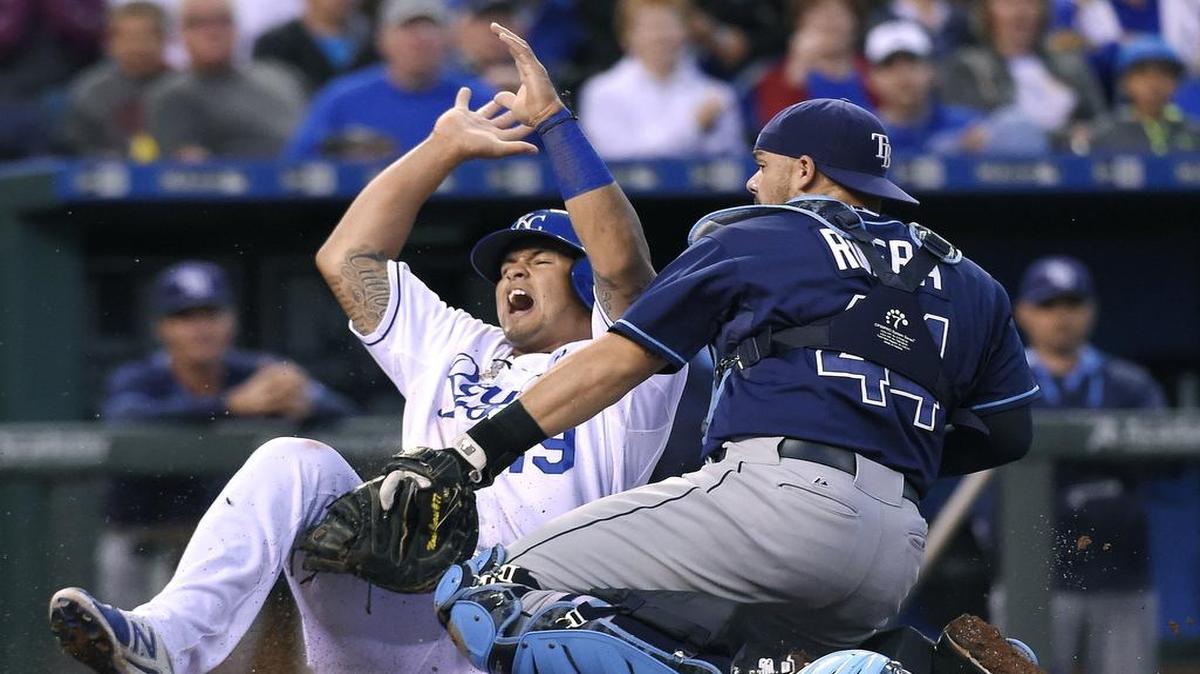 
Royals third baseman Cheslor Cuthbert (19) scores ahead of the tag from Tampa Bay Rays catcher Rene Rivera (44) on a single by Lorenzo Cain in the fifth inning of Wednesday's baseball game at Kauffman Stadium.
