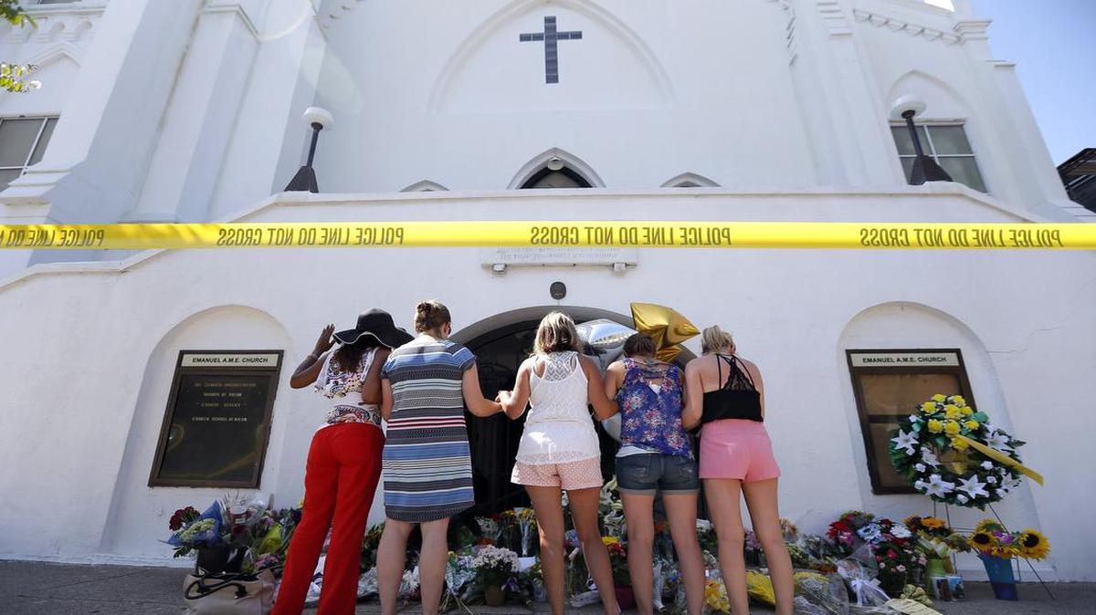 
Mourners prayed together at a makeshift memorial in front of Emanuel AME Church.
