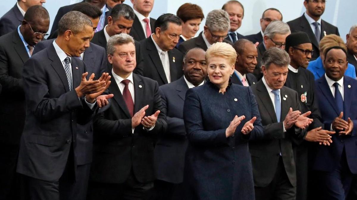 President Barack Obama (far left) applauds as world leaders posed this week for a group photo at the United Nations Climate Change Conference.